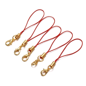 Detail of red nylon lanyards with gold lobster clasps for mobile phone accessories