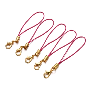 Detail of five pink braided lanyards with golden lobster clasps for DIY accessories