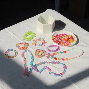 Macro detail of vibrant DIY bead set with colorful acrylic beads and handmade necklaces