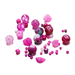 Macro shot of 8mm pink and purple glass beads set with crackle texture for DIY jewelry