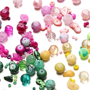 Close-up of 8mm colorful glass and resin DIY beads mix in various vibrant shapes