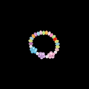 Detailed macro of kids colorful flower beads bracelet with clear petals and faux pearls