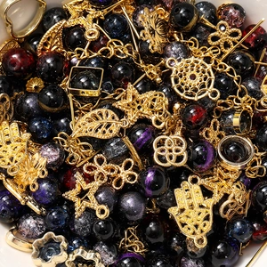 Macro shot of deep blue crystal beads and golden Hamsa Hand charms for DIY jewelry making