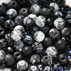 Macro view of assorted black and white DIY glass beads with crackle and leopard textures