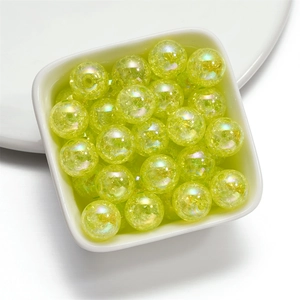 Macro shot of 16mm yellow-green crackle acrylic beads with iridescent AB coating