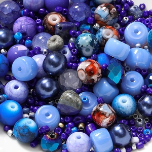 Macro shot of 8mm blue and purple glass beads in mixed textures for DIY jewelry