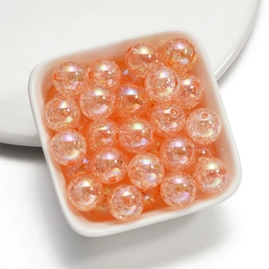 Macro detail of 16mm crackle acrylic beads with colorful orange iridescent finish