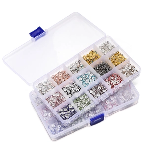 Detailed view of colorful rhinestone spacer beads in a clear 15-grid organizer box