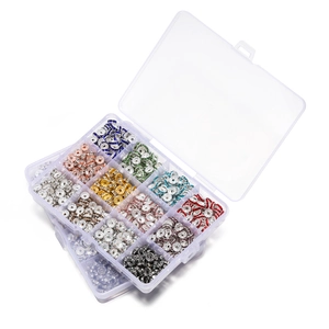 Detailed view of a 12-grid storage box filled with colorful rhinestone spacer beads