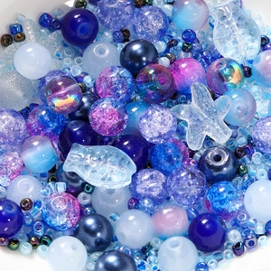 Macro shot of 8mm blue and purple glass beads set with starfish and fish charms