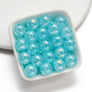 Macro view of 16mm blue crackle glass beads with iridescent AB coating in a bowl