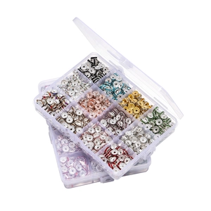 Flat lay of multiple organizers filled with colorful rhinestone spacers for DIY jewelry making