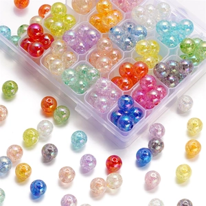 Macro shot of 16mm colorful acrylic crackle beads for DIY jewelry making in a plastic storage box