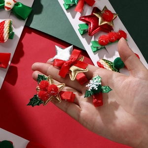 Detail of Christmas hair clips with sequins, velvet balls and festive bow decorations