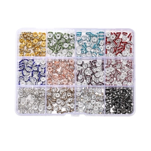 Macro shot of 12-grid storage box filled with colorful rhinestone spacer beads for DIY jewelry