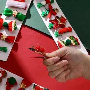Detailed close-up of Christmas themed hair clips with festive bow and glitter star