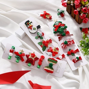 Detailed set of Christmas hair clips including snowmen and trees on display cards