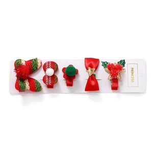 Five-piece Christmas hair clip set with festive bows and pom-poms on display card