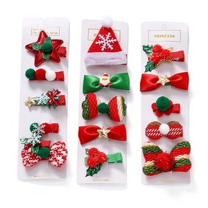 Close-up of 14-piece Christmas hair clip set with stars and trees on display cards