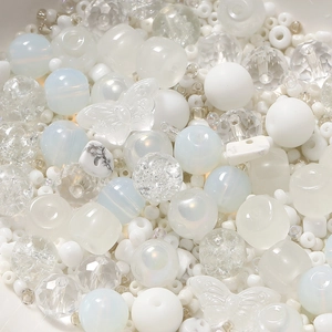 Detailed close-up of mixed white and transparent DIY craft beads in various textures