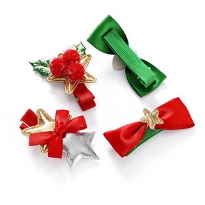 Close-up of four festive Christmas hair clips featuring bows, stars, and holly leaf details