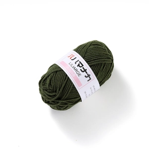 Close-up of dark green 4-ply milk cotton yarn ball with a professional white paper label