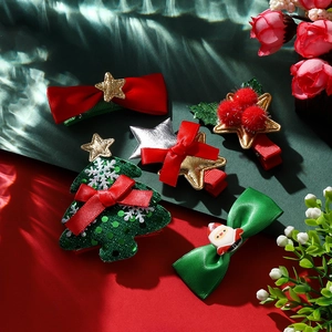 Detailed view of a 5-piece Christmas hair clip set with bows and sequin festive motifs