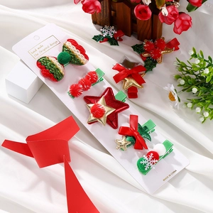 Detailed view of a 7-piece Christmas hair clip set with stars, bows, and sequins