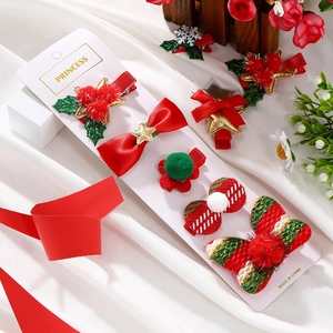 Close-up of a 5-piece Christmas hair clip set with bows and stars on a display card