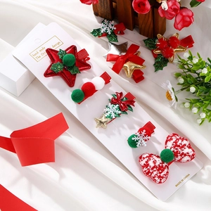 Detailed view of festive Christmas hair clips featuring bows and stars on white card