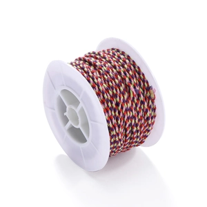 Macro shot of colorful Tibetan woven cotton cord roll for DIY jewelry making and tassels