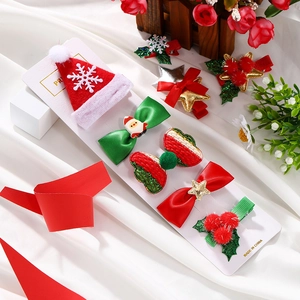 Macro detail of festive Christmas hair clips including Santa bow and glittery tree shapes