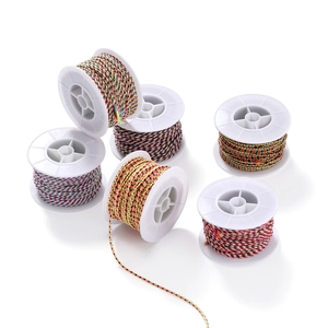 Close-up of 6 multicolored braided cotton cord spools for DIY jewelry making