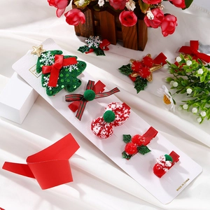 Christmas hair clips set featuring sequins, bows and plush pom-poms on display card