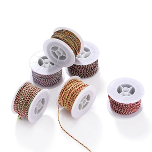 Detail of six colorful braided cotton cords on white spools for DIY jewelry making