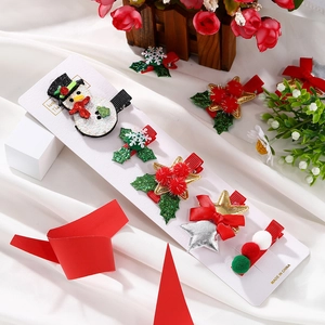 DIY Christmas hair clip set with snowman and snowflake designs on display card