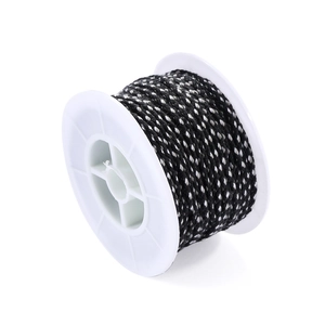 Detailed view of black and white braided nylon cord on industrial white plastic spool