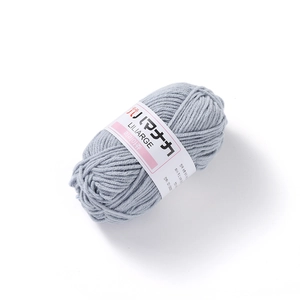 Close-up of 4-ply light grey-blue milk cotton yarn with fluffy texture and label