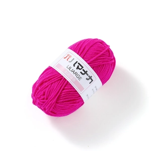 Close-up of bright pink 4-ply milk cotton yarn ball with a professional paper sleeve
