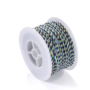 Macro detail of multi-color twisted Tibetan cotton cord wound on a white spool