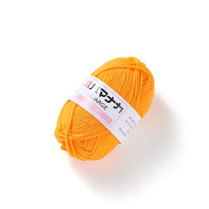 Macro detail of vibrant orange 4-ply milk cotton yarn with textured weave and brand label