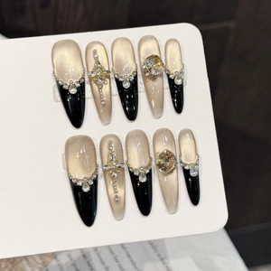 Luxury black and gold gradient press-on nails with cat-eye effect and diamond accents