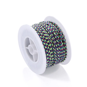 Macro shot of multi-colored braided nylon cord on white spool for DIY jewelry