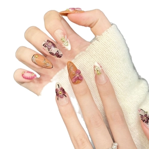 Handmade long almond press-on nails with purple floral art and gold relief accents