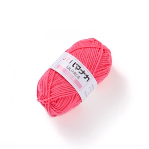 Detailed texture of vibrant pink 4-ply milk cotton yarn with Liliarge paper label