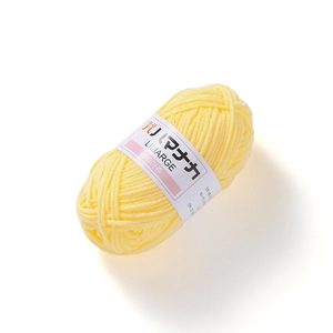Detailed close-up of soft light yellow 4-ply milk cotton yarn roll for DIY crochet doll