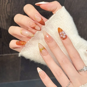 Handmade almond press-on nails with pink-orange gradient and 3D floral accents