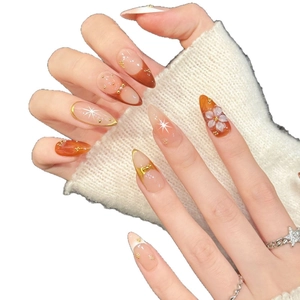 Pink and orange gradient press-on nails with 3D embossed flowers and gold foil accents