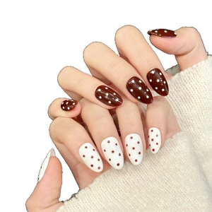 Polka dot press-on nails in red and white tones with glossy oval-shaped finish