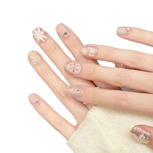 Iridescent winter snowflake press-on nails with pearls and rhinestones on hands